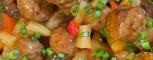 Southern California's island style meatballs. The meatballs are mixed with sweet and sour, bell peppers, pineapples, and garnished with green onions. Catering and luau entertainment company, Kahula Voyage, serves delicious sweet and sour meatballs. 