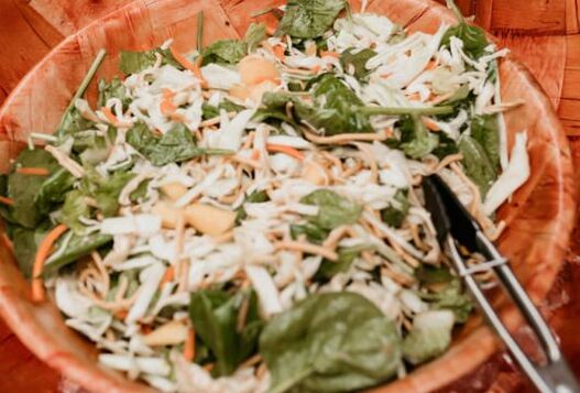 Chinese chicken salad made with Aloha. It contains mandarin oranges, wonton bits, cabbage salad, and spinach. It's topped with our homemade hawaiian secret vinaigrette, and fresh baked chicken.